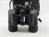 a pair of binoculars sitting next to a black case