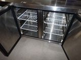 a stainless steel counter top with a refrigerator inside of it