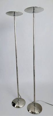 pair of chrome plated floor lamps on a white background