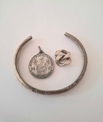 a close up of a metal object with a coin on it