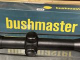 a bushmaster scope sitting on a table next to a box