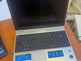 two laptops and a cell phone on a desk