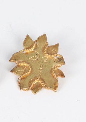 pair of gold tone flower earrings with leaves on a white background