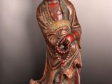 statue of a woman holding a bunch of grapes in her hands