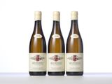three bottles of wine sitting on top of a table