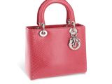 a pink handbag with a metal handle on a white background