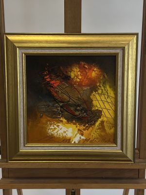 a picture of a painting on a easel in a room