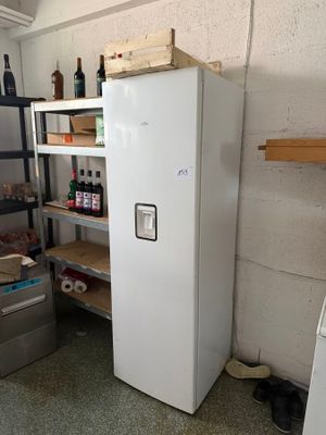 a white refrigerator in a room with shelves and shelves
