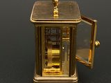 a gold clock that is sitting on a table
