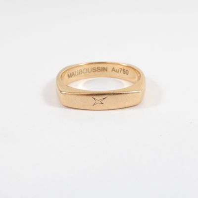 a close up of a gold ring on a white surface