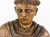 a wooden statue of a man with a hat on his head