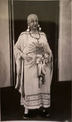 an old black and white photo of a woman standing in a doorway