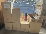 several boxes of soda are stacked on top of each other in front of a window