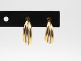 a pair of gold hoop earrings on a black hook