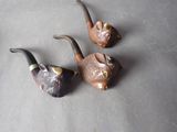 three pipe holders that are sitting on a table