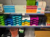 a shelf full of assorted office supplies in a store