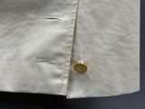 a close up of a white shirt with a button on it