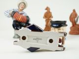a miniature figurine of a man with a guitar and other figurines in the background