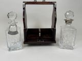 three glass bottles and a wooden box on the table