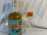 une bouteille d'alcool posée sur un lit, avec une étiquette de prix