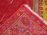 a close up of a red and yellow area rug
