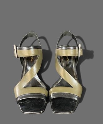 pair of women ' s shoes on a gray surface with a gray background