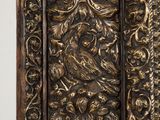 a close up of a wooden door with ornate carvings on it