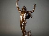 an image of a bronze statue of a man with a dog
