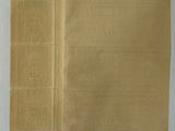 a close up of a piece of brown paper on a white surface