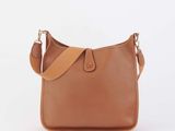 a brown leather shoulder bag on a white background
