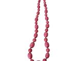 a close up of a pink necklace on a white background