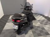 a motorcycle that is parked in a room with a checkered floor