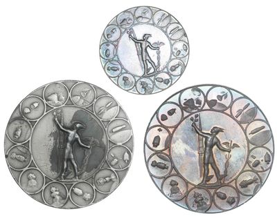 three metal plates with a picture of a man and a woman on them