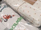 two packages of baby clothes sitting on top of each other