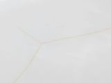 a close up picture of a white marble table top