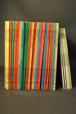 a lot of books that are stacked on top of each other