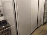 several refrigerators are lined up in a row in a kitchen