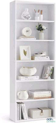 a white bookcase with many books on top of it