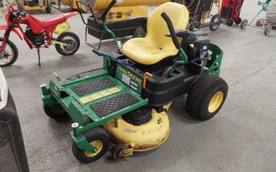 a lawn mower that is parked in a garage