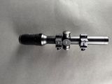 a close up of a rifle scope on a metal surface