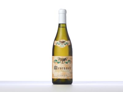 a bottle of white wine sitting on top of a table