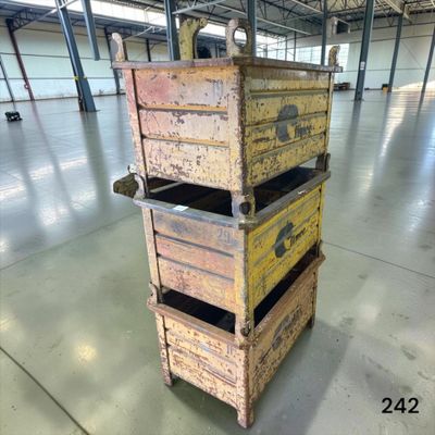 three wooden crates stacked on top of each other in a warehouse
