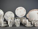 many different types of porcelain dishes and cups on the table