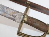 a close up of a sword on a white surface