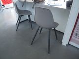 two chairs that are sitting in front of a desk