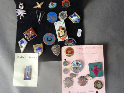 a lot of pins and brooches on a table