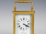 an image of a gold clock with roman numerals on the face
