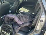 the back seat of a car with a sleeping bag in the back of it