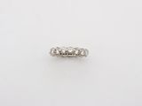 an image of a five stone diamond ring on a white surface