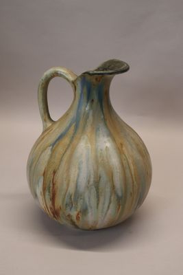 a picture of a ceramic vase with a curved handle